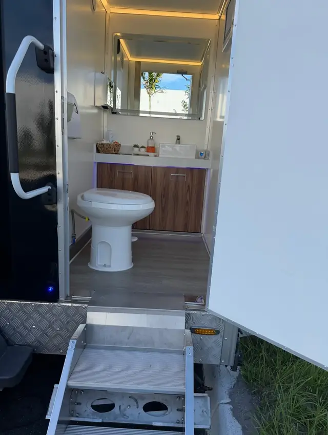 Restroom trailer vanity and toilet